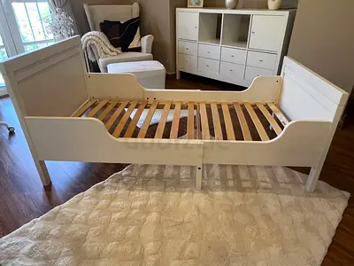 IKEA Sundvik extendable White toddler bed frame with slats and foam mattress.