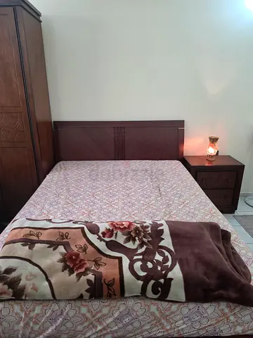 Solid wood queen bed frame with free mattress + matching bedside table + lamp