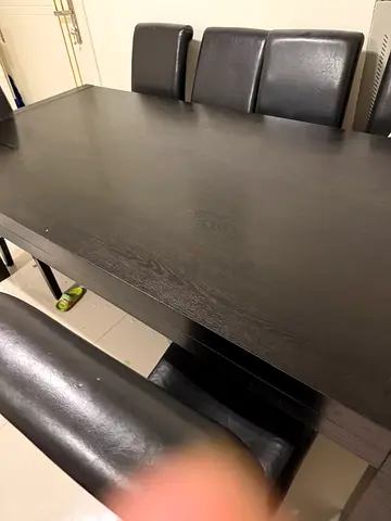 Dark wood dining table with 8 black leather chairs - good condition ,2 chairs have little torn
