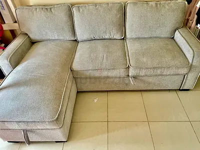 Light grey L-shaped fabric sofa with chaise, good condition