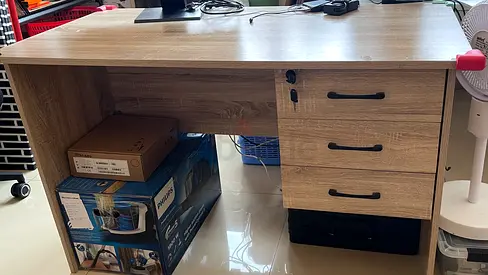 Used wooden office desk with three drawers — good condition
