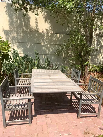 Big wooden outdoor table with 8 matching chairs