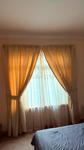 Pair of beige fabric curtains with tiebacks - ready to hang