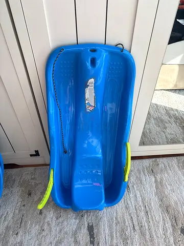 Blue plastic snow sled with handles and pull rope - good condition