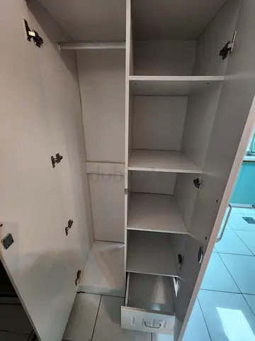 White freestanding wardrobe with shelves and hanging rail