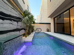 Modern villa with high-quality custom finishing for sale in Ajman; includes electricity, water, and
