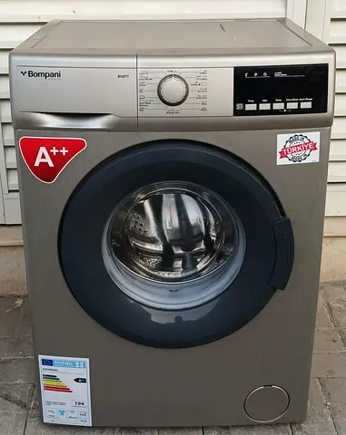 Front load 7kg Bompani brand washing machine. Gray color, condition is good working.