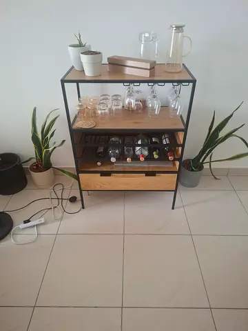 Compact wooden and black metal bar cart with wine rack and glass holders
