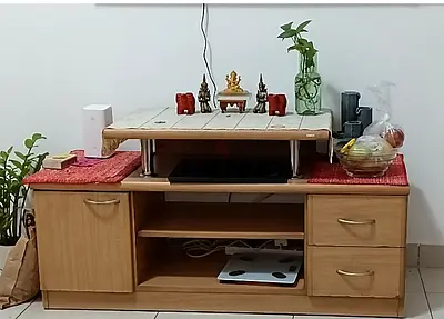 Light wood TV cabinet with drawers and storage shelves