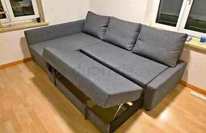 L-shaped grey fabric sofa bed with storage — good condition