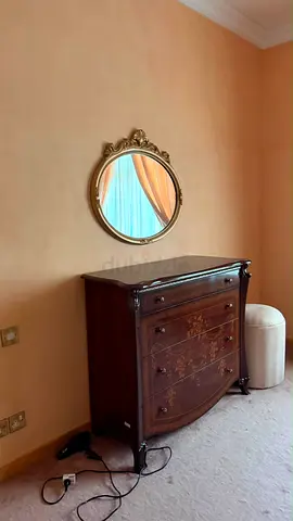 Antique-style Wooden Dresser with Decorative Inlay and Round Wall Mirror
