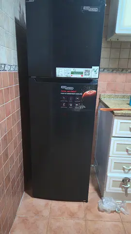 Black double-door refrigerator in good working condition under warranty