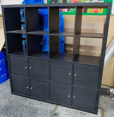 Large black wooden kalax shelving unit with 8 cubbies and 8 cabinets