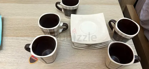 Set of 5 small ceramic coffee cups with matching saucers