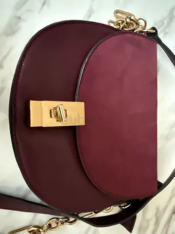 Maroon leather crossbody bag with gold clasp