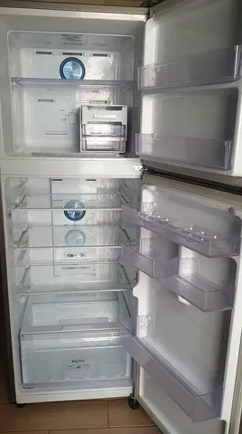 Clean white double-door refrigerator — good working condition