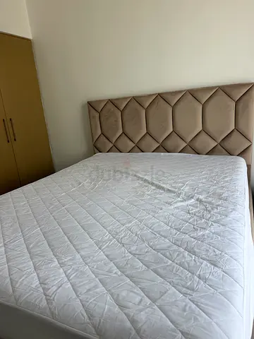 Ottoman Queen bed with padded beige headboard and mattress - great condition