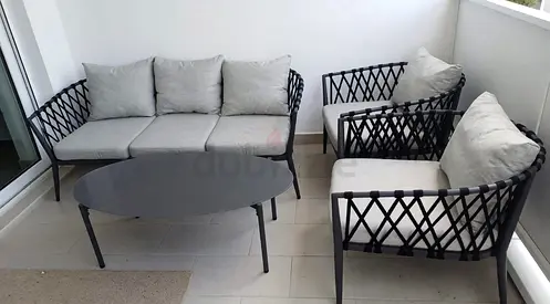 Outdoor patio sofa set with two armchairs and coffee table - light grey cushions