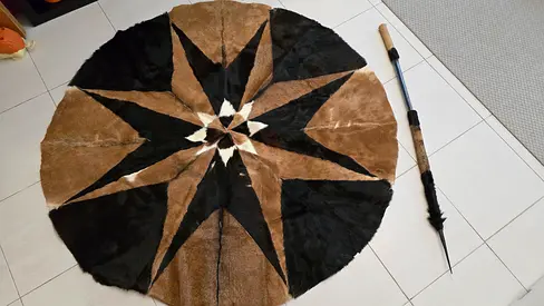 Genuine round cowhide rug — brown & black star design, good condition