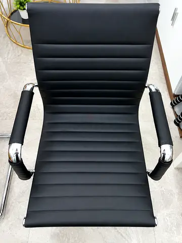 Black modern office chair with chrome arms — good used condition