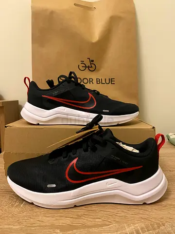 Black Nike Running Shoes with Red Swoosh - Like New, Size Not Specified