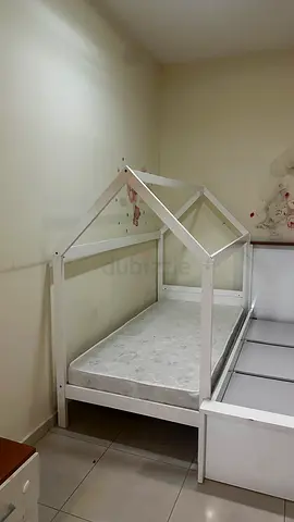 White wooden house-frame single children's bed with mattress