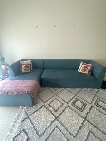 L-shaped teal fabric sofa with ottoman, good condition - AED 50 - 200