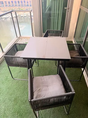 4-piece outdoor dining set with cushions — compact balcony size