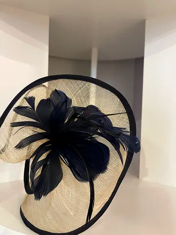 Navy and cream fascinator hat with feather detail