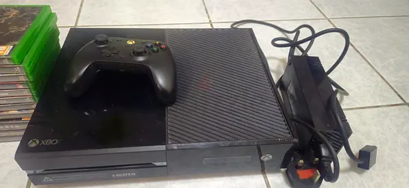 Used Xbox One console with controller, power brick and games