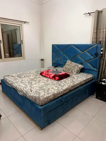 Blue upholstered double bed with storage, good condition