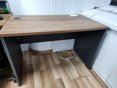 Simple wooden office desk suitable for compact office spaces. 4 units available at AED 300 per unit