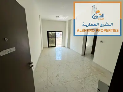 First-occupancy unit in Al Alia: spacious one-bedroom apartment with a living room, two bathrooms (including a master), a balcony, and built-in wardro
