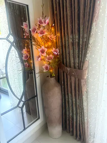 Brown tall stoneware vase with flower n lights arrangement