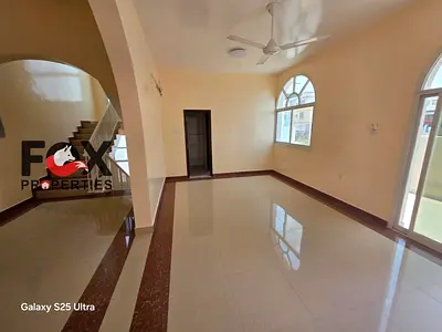 Villa for Sale in Al Rawda 2, Ajman. Land area: 10,000 sq. ft., 5 bedrooms, 3 spacious living rooms, plus an external annex with a kitchen and room. A