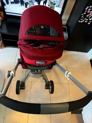 Red compact pram stroller in good condition