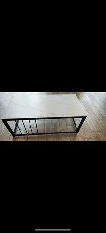 Modern rectangular coffee table with white marble top and black metal frame