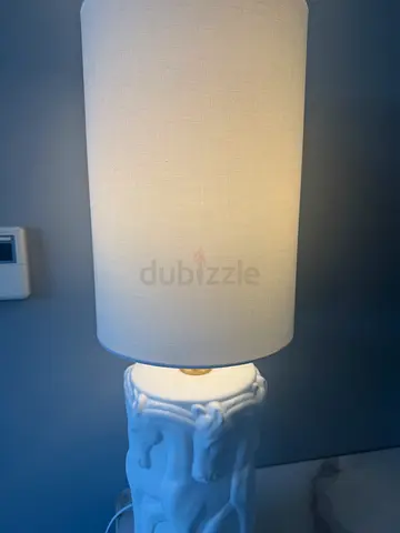 Pair of white ceramic table lamps with fabric shades and horse detail