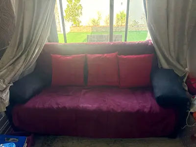 2-seater burgundy sofa bed with cushions - good condition