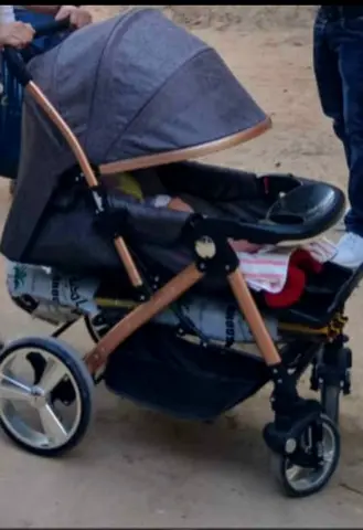 Grey reclining baby stroller/pram with large storage basket.