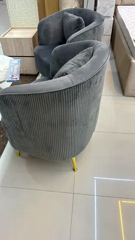 Pair of grey velvet ribbed lounge chairs with gold legs