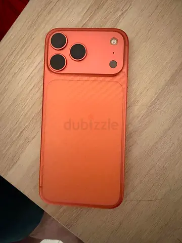 Orange iPhone with protective case and camera covers - good condition