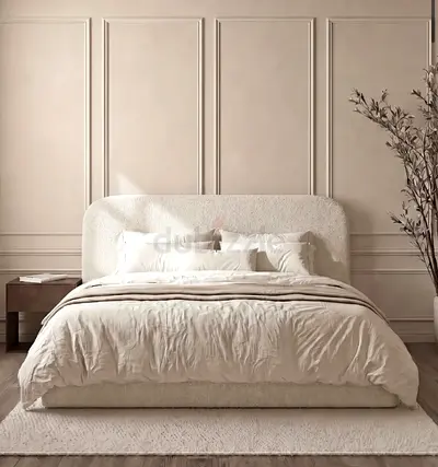King size upholstered bed with plush headboard in cream