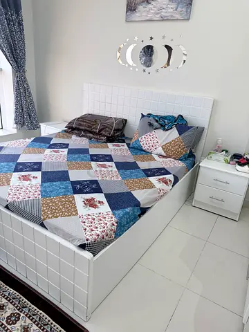 White single bed frame with mattress and bedside drawer