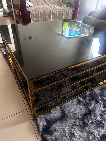 Gold metal and glass coffee table - modern design . Coffee table - 110 by 110
Height - 40
