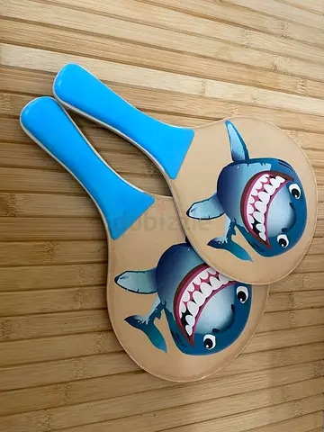 Pair of kids beach paddle rackets with shark design
