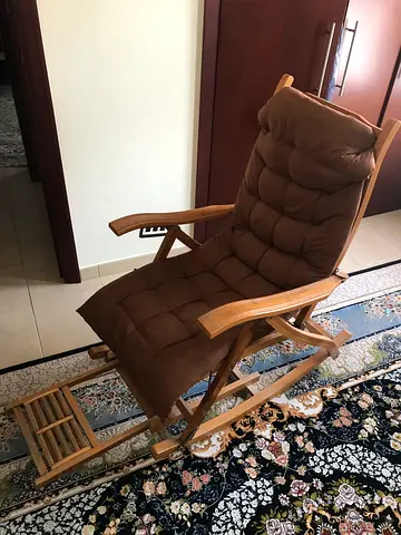 Wooden rocking lounge chair with cushioned seat — good condition