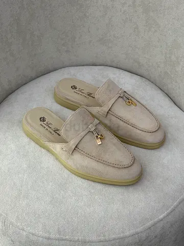 Light beige suede slip-on mules with gold charm - size not specified