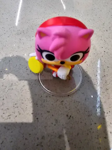 Small amy collectible toy figure on display stand funko pop