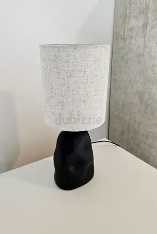 Bedside table lamp with beige fabric shade